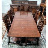 A 1930's Carolean oak dining suite comprising drawer-leaf table on bulbous supports and a set of 5