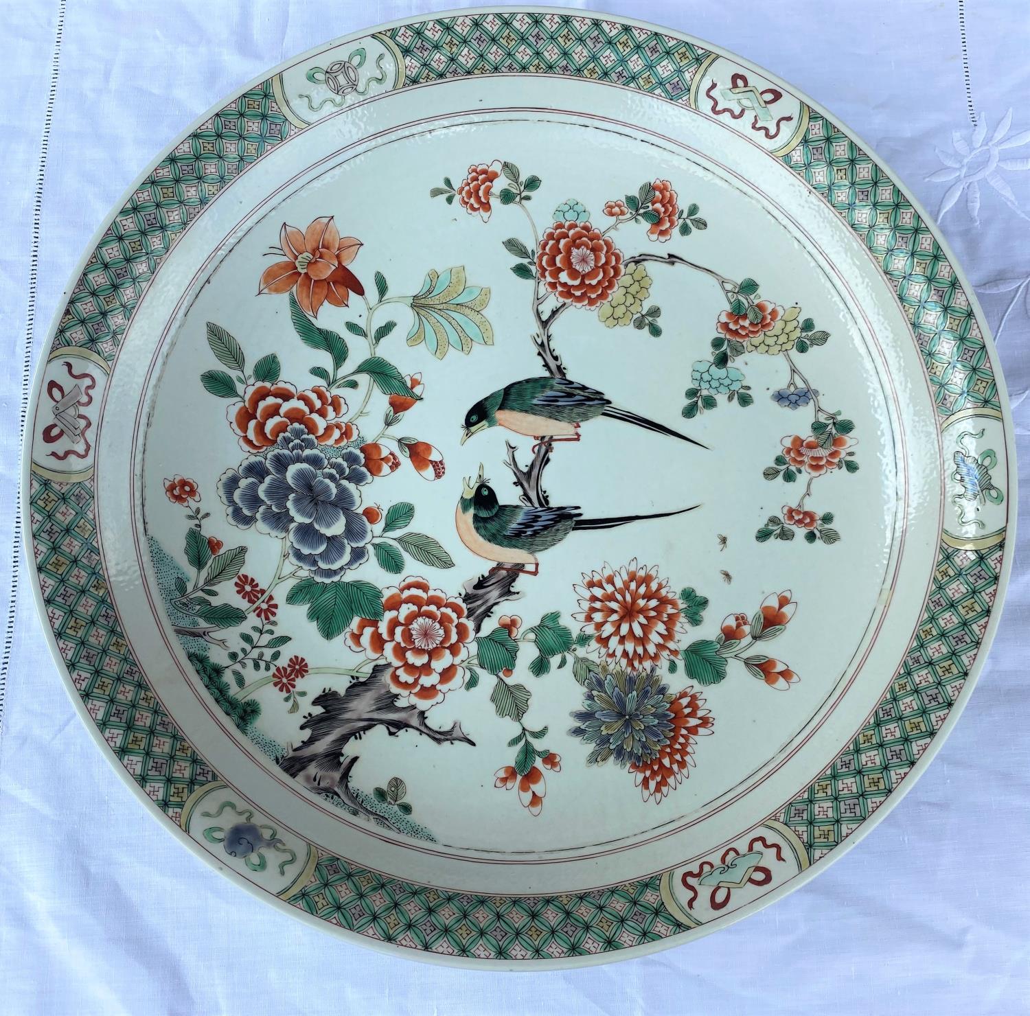 A large Chinese famille verte charger decoarted with flowers and birds on a branch, diameter 43cm