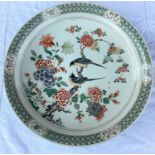 A large Chinese famille verte charger decoarted with flowers and birds on a branch, diameter 43cm