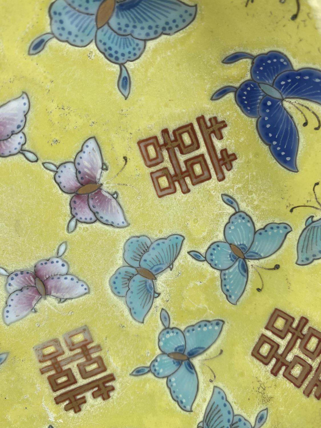 A pair of Chinese yellow ground dishes decorated in polychrome with butterflies to the interior - Image 3 of 6