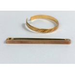 A modern wedding ring stamped '70', cut; a yellow metal bar brooch, stamped '9ct', 1 gm
