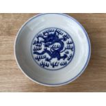 A Chinese blue and white dish with central dragon decoartion and seal mark to base,, diameter 17cm