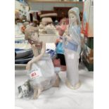 Two Lladro figures: girl on the telephone & girl with lilies