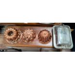 A silver plated entree dish; 3 copper jelly moulds