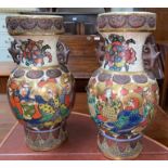 A pair of oriental crackle glaze vases decorated with men with gilt haloes holding lanterns,