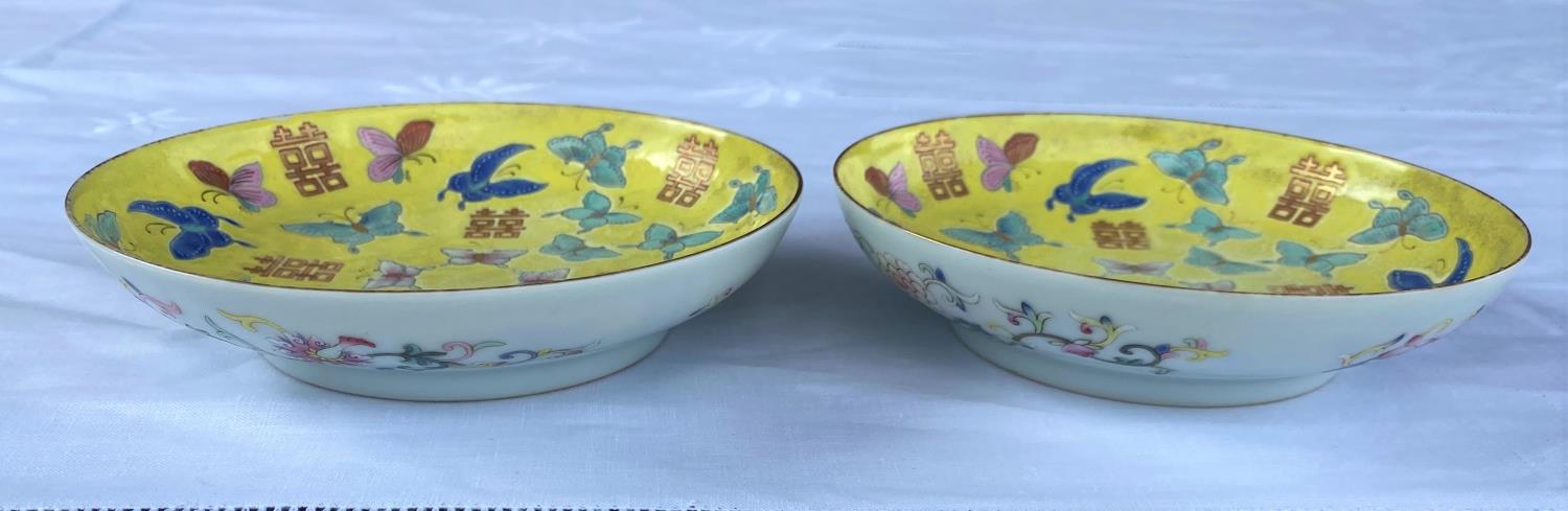 A pair of Chinese yellow ground dishes decorated in polychrome with butterflies to the interior - Image 2 of 6