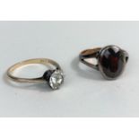 A 9 carat hallmarked gold ring set oval garnet; a yellow metal ring set clear stone, stamped 9ct