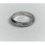 A white metal wedding ring stamped 'Plat', 7.3 gm