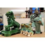 A stoneware figure of a Chinese warrior; a Dog of Fo; etc.