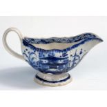 An 18th century Liverpool pearlware sauce boat with blue & white chinoiserie decoration