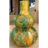 A Chinese yellow and green double gourd vase with dripware glaze and decoration in relief, height