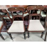 An early 19th century set of 4 mahogany dining chairs with wide top rails, drop in seats in brown,