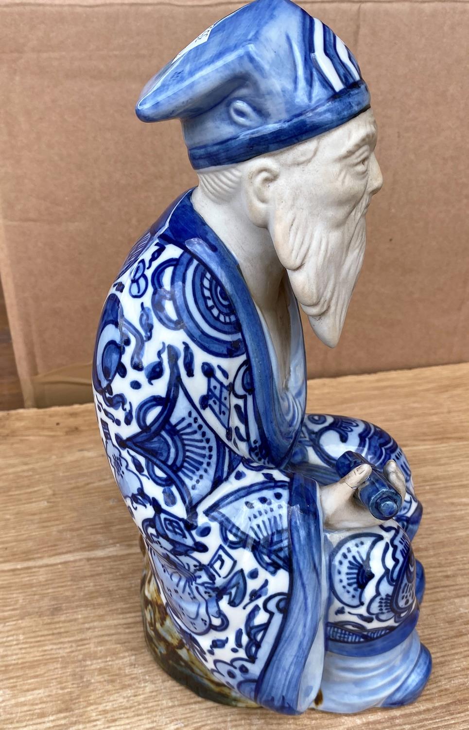 A Chinese figure of a seated man with beard in blue and white glazed robes, impressed mark to - Image 2 of 5