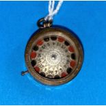 An unusual yellow metal fob set with a roulette wheel with chased decoration, unmarked