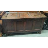 A late 17th century early 18th century framed and panelled oak bedding box with hinged lid and