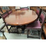 A Jacobean style oak dining suite comprising oval drop leaf table and 6 (4+2) chairs with carved top