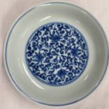 A blue and white Chinese plate with circular central floral panel, circular floral border to outside