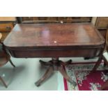 A Regency period mahogany fold over table, the rounded rectangular top with crossbanding and ebony