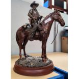 A figure of John Wayne on horseback, and others related