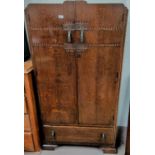 A 1930's oak tallboy with double door fitted section and drawer under