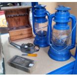 A reproduction pair of hanging oil lamps; a wooden pipe rack with drawer