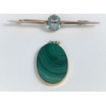 A bar brooch set cushion cut aquamarine coloured stone, marks unclear, 3.9 gm; an oval malachite