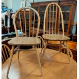 An Ercol pair of dining chairs in lightwood and elm, with stick backs; a modern set of 4 ladder back