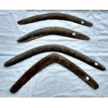 Four Aboriginal tribal carved boomerangs, one with carved decoration, longest 66cm, shortest 54cm