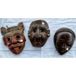 Three various carved wooden masks