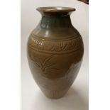 A Chinese stone ware baluster vase with tea dust coloured ground with incised decoration height 23cm