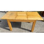 A modern rectangular extending light oak occasional table