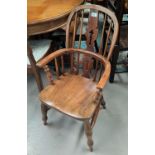 A 20th century elm and stained wood child's Windsor armchair