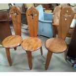 A set of 4 handmade 'spinning' chairs with pierced backs, on triple legs