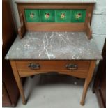 An Edwardian marble top wash stand with tile back & frieze drawer. (front panel & leg at fault)