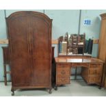 A burr walnut bedroom suite in the Queen Anne style comprising part fitted wardrobe, kneehole