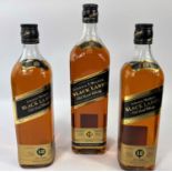Two 70 cl bottles of Johnnie Walker 12 year old Black Label; a litre bottle, boxed