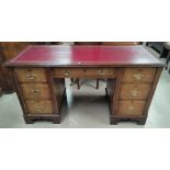 An early 20th century stained walnut kneehole desk with inset top, 7 drawers and chair