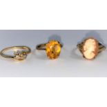 A yellow metal ring stamped '18ct', set 2 crossover diamonds (1 stone missing), 1.8 gm; a cameo ring