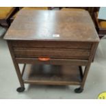 A 1930's oak sewing box/trolley with hinged lid and drawer; a mahogany fire screen and occasional