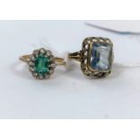 A yellow metal dress ring stamped 9ct set with central green stone, surrounded by clear stones, 2.