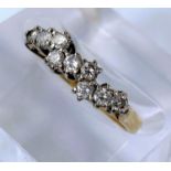 A yellow metal dress ring set with three rows of diamonds, stamped 18ct, 3.8gm.
