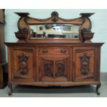 A late 19th century Scottish golden oak mirror back sideboard with extensive carved decoration to