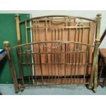 A Victorian brass bed with railed ends and swag decorations