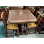 A 1930's carved oak dining suite comprising draw-leaf dining table (a.f.underneath), 4 chairs