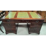 A Mahogany reproduction pedestal desk with green leather effect writing surface, three drawers to