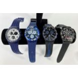 Four various Swatch Swiss Chronograph watches, two in blue, two in black