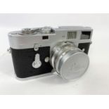 A LEICA M2 chrome 35mm camera c.1960, serial no 966842, with 35mm f2 Summicron lens, leather E.R.