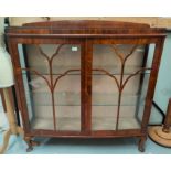 A 1930's walnut 'D' front display cabinet enclosed by 2 doors on cabriole legs