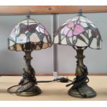 A pair of modern table lamps with floral and tiffany style shades.