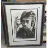 A limited edition photo print of John Lennon smoking, signed Spud Murphy in pencil 497/750